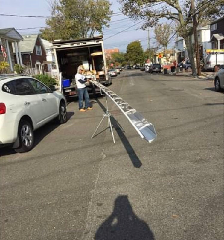 Ladder set up on a Brooklyn street for a roof repair