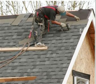 Roofers installing new shingles